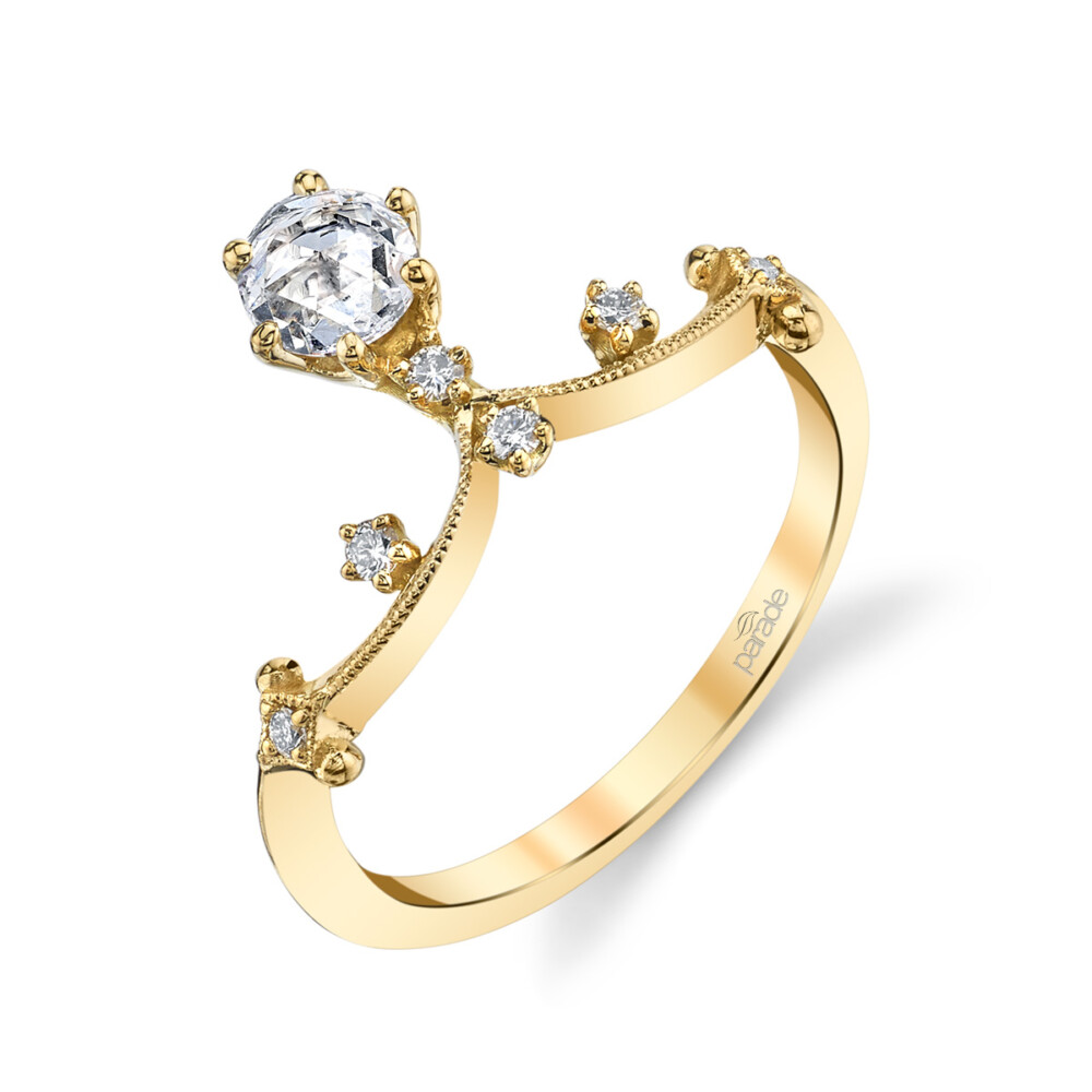 A brilliant half carat round diamond set in a classic 6 prong crown floats from a wave of fine 18k gold finished with intricate milgrain detailing, sprinkled with sparkling white diamonds in this subtle and feminine engagement ring from the Lumiere Bridal Collection.